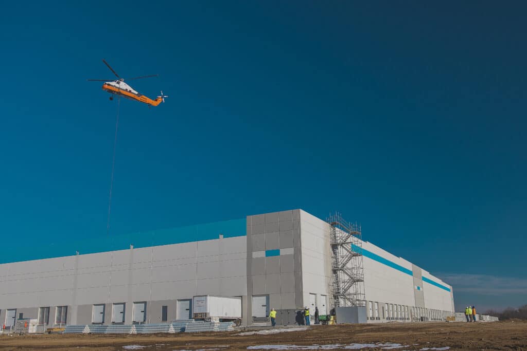 an in progress job site with a helicopter flying above